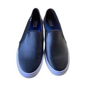 Keds womens slip-on sneakers with a black upper and blue "SoftFoam" insoles